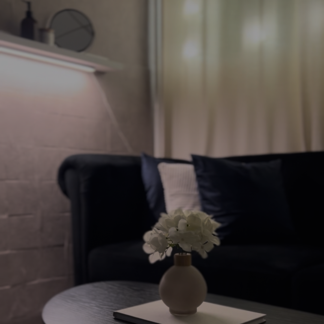 Vase with white flowers on a table in a living room setting